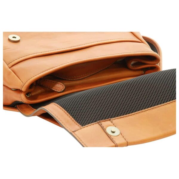 A close-up, angled view of a tan leather messenger bag or backpack with the main flap flipped open. The underside of the flap features a dark gray breathable mesh lining and a round magnetic snap closure. The open compartment reveals additional leather layers, a zippered pocket, and meticulous stitching, highlighting the bag's craftsmanship and functional design.