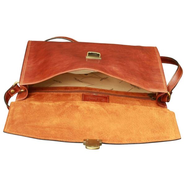 An open view of a brown leather messenger bag from above, showing a spacious interior with patterned fabric lining, a zippered internal pocket, a suede-lined flap, and a brass tuck-lock clasp.
