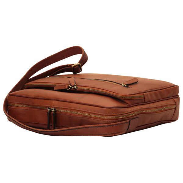 A side-angle view of a tan leather briefcase or messenger bag lying flat, showcasing multiple zippered compartments, antique brass-style hardware, and a matching adjustable shoulder strap.
