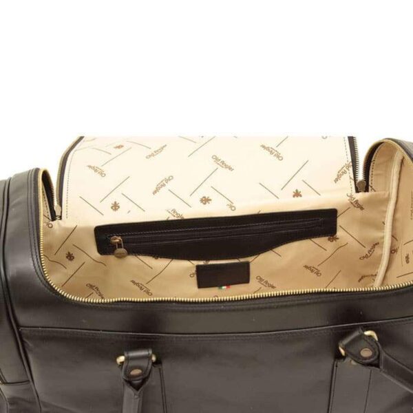 An open black leather bag revealing a cream-colored fabric interior lining with a repeat logo pattern, an internal zippered pocket, and a leather brand patch with a small Italian flag detail.