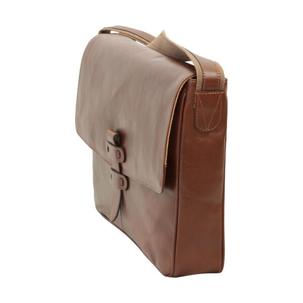A side profile view of a slim brown leather messenger bag with a large front flap, adjustable leather strap with canvas reinforcement, and a vertical leather closure tab.