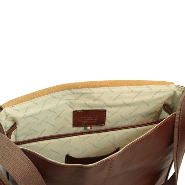 An interior view of a brown leather bag showing a cream-colored fabric lining with "MADE IN ITALY" branding, multiple internal pockets, and an "OLD ANGLER" leather patch with an Italian flag.