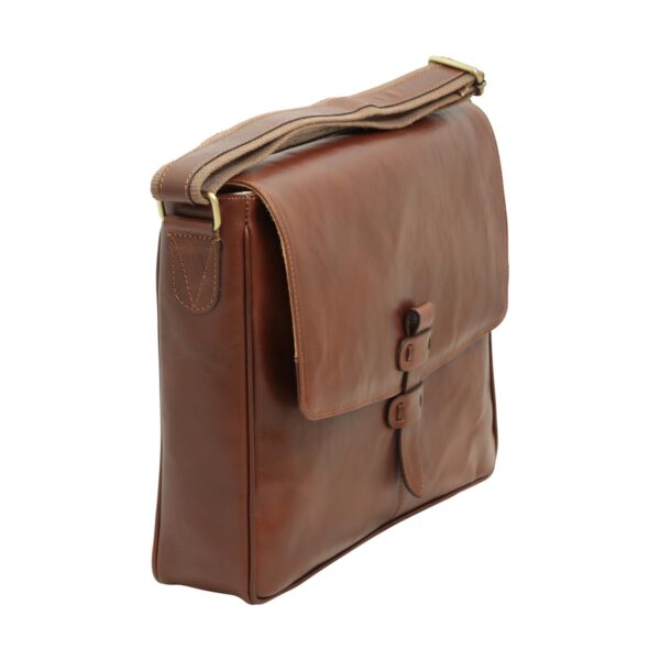 A side view of a brown leather messenger bag from the opposite angle, showing the brass hardware, adjustable shoulder strap, and large front flap with leather strap closure.