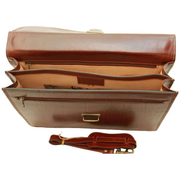 Top-down interior view of an open brown leather briefcase showing two main compartments, zippered pockets, and a detachable shoulder strap