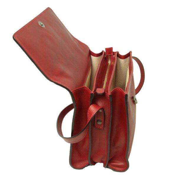 An interior view of an open red leather messenger bag, showcasing its triple-compartment design. The center section features a gold-tone zipper for security, while the outer sections are open with a light-colored lining. The image highlights the magnetic snap closure on the underside of the flap.