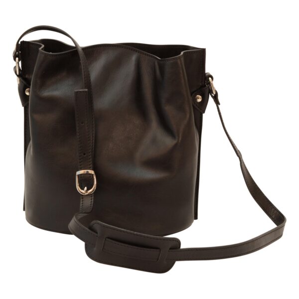 A front-facing view of a black leather bucket bag, showing a long, adjustable shoulder strap with a silver-toned buckle and a sliding leather shoulder pad. The bag has a relaxed, draped silhouette and a structured round base.