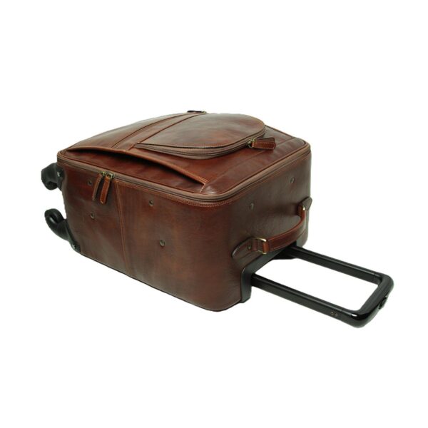 A high-angle view of a **brown leather carry-on suitcase** lying on its side, showing the **telescopic handle** fully extended. The image highlights the bag's rich texture, reinforced leather side handle, and various zippered compartments, set against a plain white background.