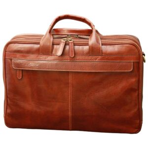 A front view of a closed reddish-brown leather briefcase, highlighting its multi-compartment design with several top zippers, sturdy rolled handles, and a large front pocket with a decorative leather trim, set against a white background.