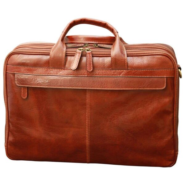 A front view of a closed reddish-brown leather briefcase, highlighting its multi-compartment design with several top zippers, sturdy rolled handles, and a large front pocket with a decorative leather trim, set against a white background.