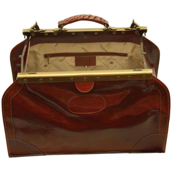 Interior view of an open leather doctor bag with a wide brass frame, branded fabric lining, and a large internal zippered compartment