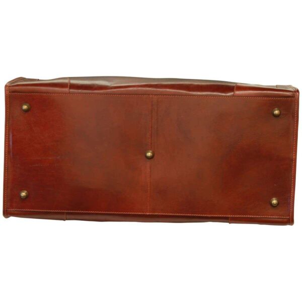 Bottom view of a brown leather bag showing five protective brass metal feet and reinforced stitching
