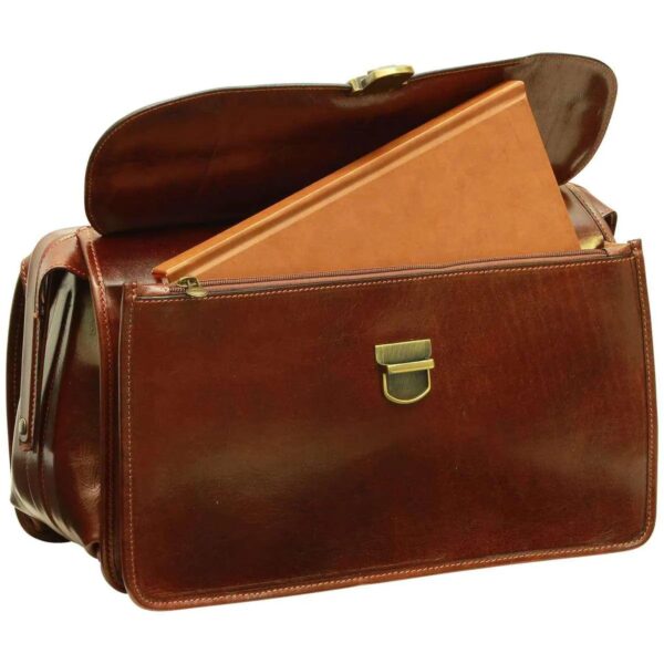 A front view of a brown leather bag with its large front flap open, revealing a tan leather-bound book tucked into a zippered interior compartment, featuring a brass tuck-lock clasp on the front pocket, isolated on a white background.