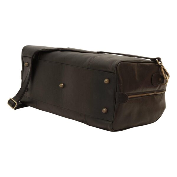 A bottom view of a dark brown leather duffel bag, showing five brass-tone metal feet for protection and a reinforced leather base.