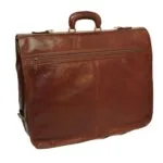 A front view of the **brown leather garment bag** folded into its carrying position, resembling a large briefcase. It features a sturdy **top handle**, a full-width horizontal **zippered pocket** on the front, and elegant brass-toned hardware.