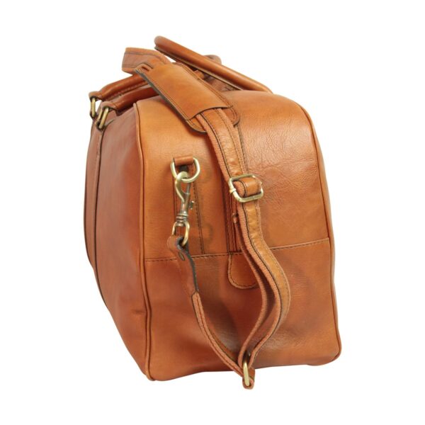 A side-angled view of a tan leather duffel bag featuring a detachable shoulder strap with brass hardware and reinforced carrying handles, isolated against a white background.