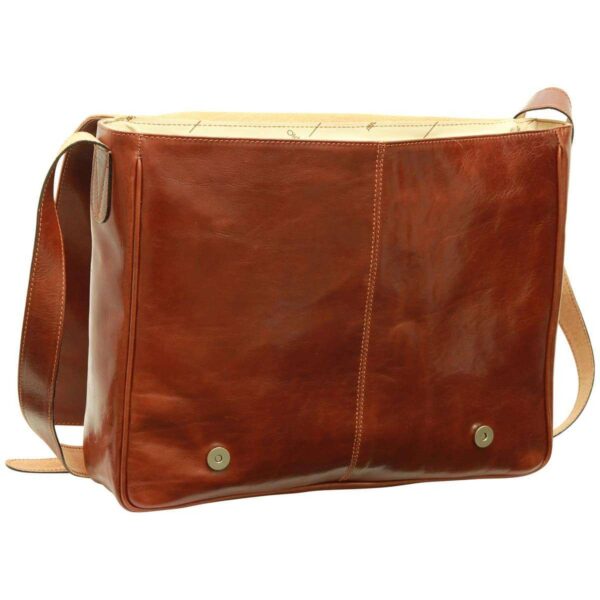 A front view of a reddish-brown leather messenger bag with its flap open, revealing two magnetic snap buttons on the front panel and a cream-colored patterned interior lining, set against a white background.