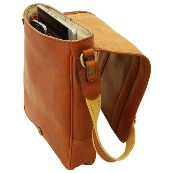 Side view of an open tan leather messenger bag featuring internal compartments holding a tablet and a smartphone