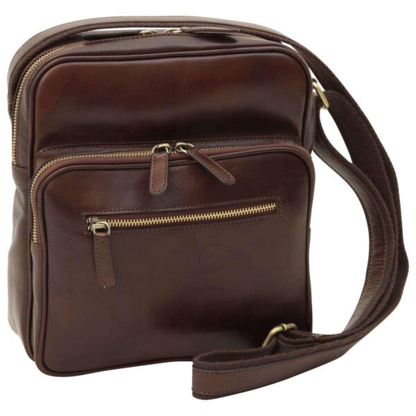 Three-quarter front view of a dark brown, polished leather messenger bag, highlighting its tiered design with multiple brass-zippered compartments and a sturdy, adjustable shoulder strap.