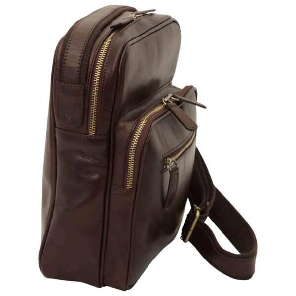 Side-angled view of a dark brown leather messenger bag featuring multiple zippered compartments and a matching adjustable shoulder strap against a plain white background.
