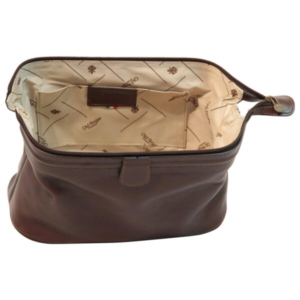 Interior view of an open dark brown leather wash bag or toiletry kit, showing a spacious main compartment with branded beige fabric lining. Features include an internal side pocket with a leather logo patch, an Italian flag detail, and a wide top zipper closure.