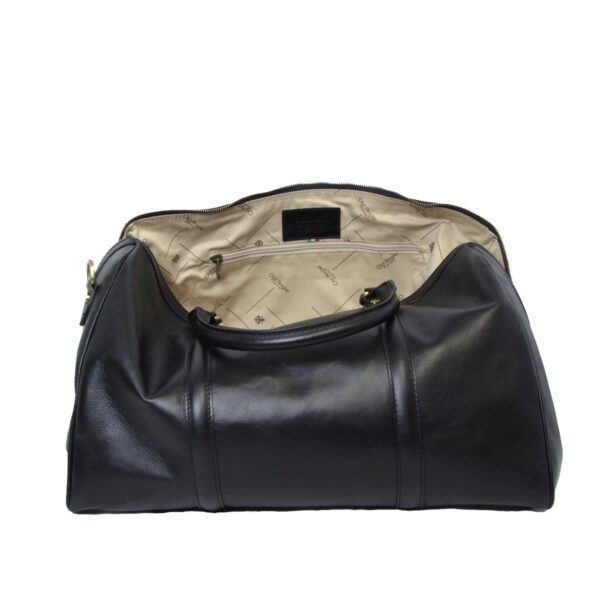 An open view of a black leather duffel bag, showing a cream-colored fabric lining with a patterned logo, an interior zippered pocket, and sturdy leather top handles.
