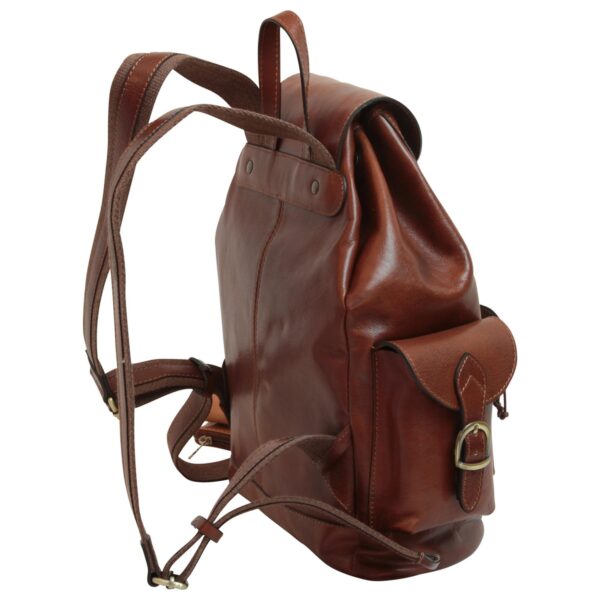 A classic brown leather backpack shown from a side-three-quarter angle, featuring a drawstring main compartment under a top flap, adjustable shoulder straps, and a small exterior side pocket with a brass buckle closure.