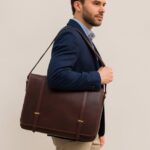 Luxury full-grain leather messenger bag with padded laptop compartment, magnetic flap closure, and adjustable shoulder strap for business, travel, and daily use