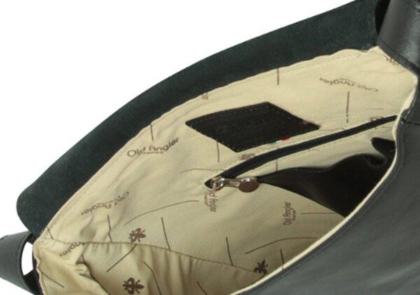 Close-up interior view of an open black leather bag, showing a cream-colored fabric lining with the "Old Angler Firenze" logo, an internal zippered pocket, and a dark leather brand patch.