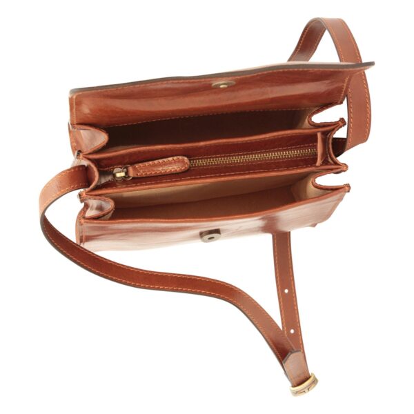 An overhead view of the interior of a brown leather shoulder bag, revealing an accordion-style construction with three main compartments, including a central zippered pocket. The bag features a tan-colored lining, a magnetic snap closure, and a long adjustable leather strap.