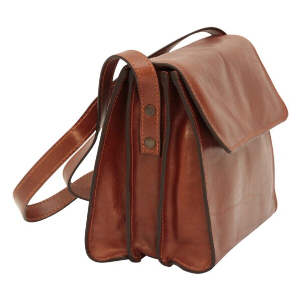 A side view of a structured brown leather messenger bag featuring an accordion-style design with multiple compartments, a large fold-over flap, and a long leather shoulder strap secured with bronze-toned rivets.