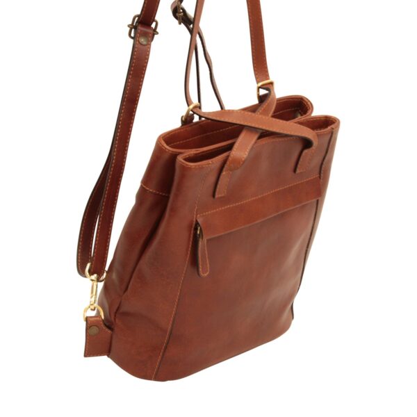 A three-quarter view of a cognac-brown leather handbag, showcasing its multi-compartment design, adjustable shoulder straps with gold-toned swivel clasps, and a front horizontal pocket with a leather pull tab.