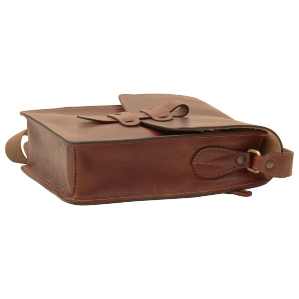 A side view of close, rectangular brown leather messenger bag lying flat, showing the interior lining and a smartphone tucked inside, with a canvas shoulder strap attached to the side.
