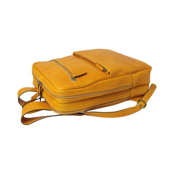 `Yellow mustard genuine leather laptop backpack lying flat showing top zip pocket, main zipper compartment and adjustable shoulder straps, top-down angle view`