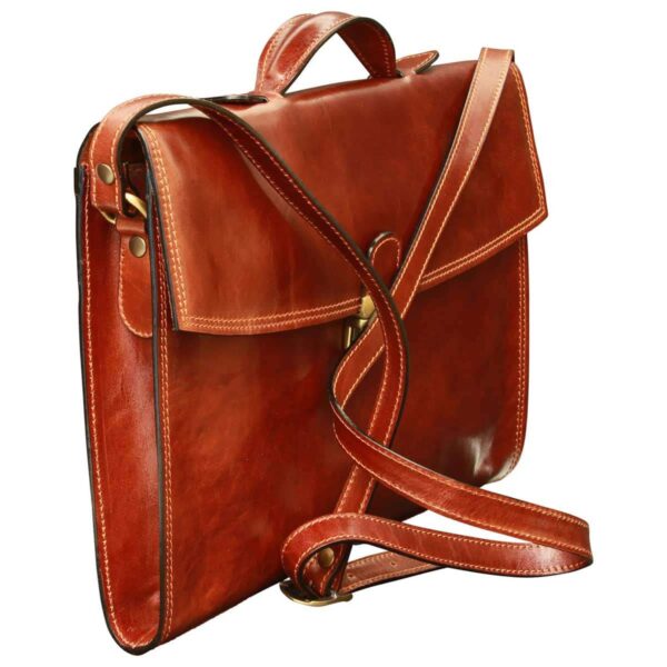 A front view of a classic brown leather briefcase featuring a top handle, an adjustable leather shoulder strap with a brass buckle, and a secure brass tuck-lock clasp on the front flap.