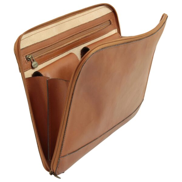 A side view of the open tan leather portfolio, showcasing its expandable multi-compartment interior. It features a large zippered pocket, two smaller flapped pouches, and cream-colored lining, all secured by a wrap-around perimeter zipper with an antique brass pull.