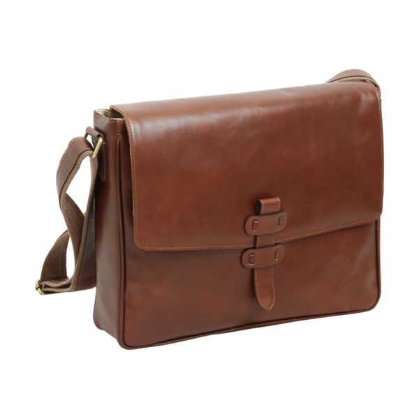 A three-quarter front view of a tan leather messenger bag featuring a large rectangular flap and a vertical leather strap closure with two loops. A brown canvas shoulder strap is attached to the side with brass hardware.