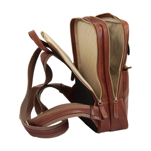 `Tan genuine leather laptop backpack shown open revealing patterned beige interior lining with multiple compartments, antique gold zippers and adjustable canvas shoulder straps, side angle view`