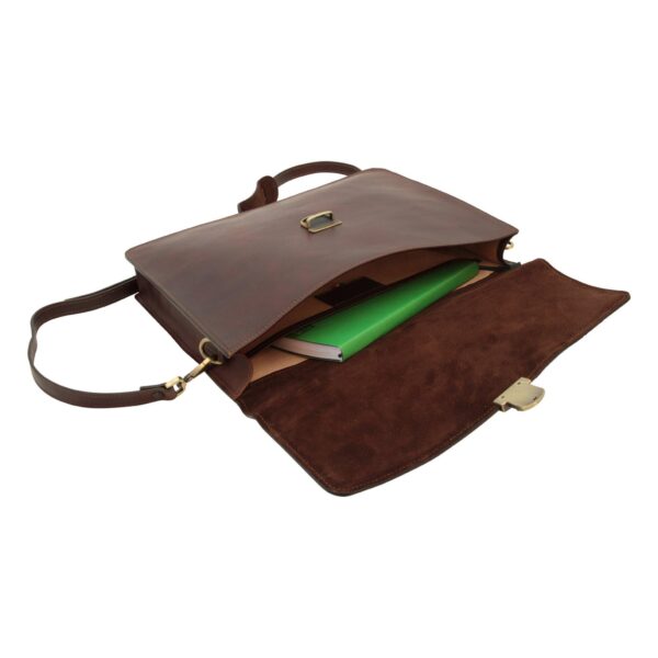 An open brown leather briefcase on a white background, featuring a suede-lined flap and a bright green book inside.