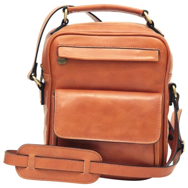 `Tan genuine leather compact crossbody bag with front flap pocket, slip pocket, Made in Italy badge, antique gold hardware, top carry handle and adjustable shoulder strap with pad, front angle view`