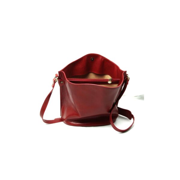 An open red leather bucket bag shown from a front-facing angle, revealing a tan interior lining, an internal zippered pocket, and a magnetic snap closure, isolated on a white background.
