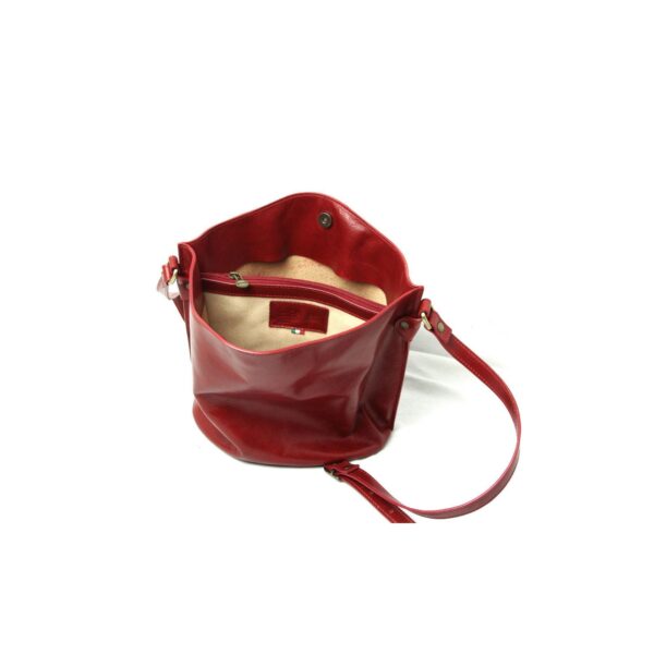 An open red leather bucket bag shown from a front-facing angle, revealing a tan interior lining, an internal zippered pocket, and a magnetic snap closure,