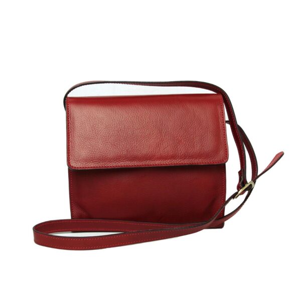 A red textured leather crossbody bag with a rectangular silhouette, featuring a front flap closure and a slim adjustable shoulder strap against a white background.