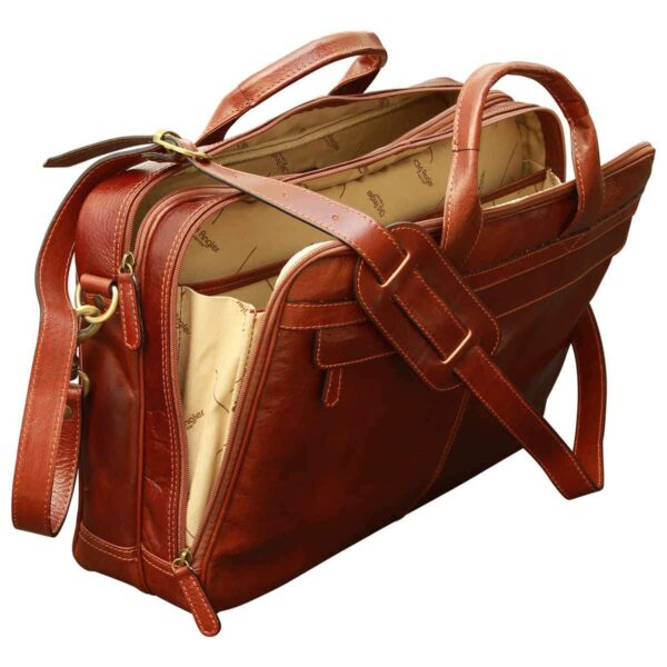 A high-gloss, reddish-brown leather briefcase featuring multiple zippered compartments, dual top handles, and an adjustable shoulder strap with a padded section, showcasing a spacious patterned interior against a white background.