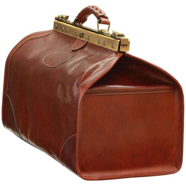 Three-quarter side view of a brown leather doctor bag highlighting its spacious structure, brass frame closure, and side profile