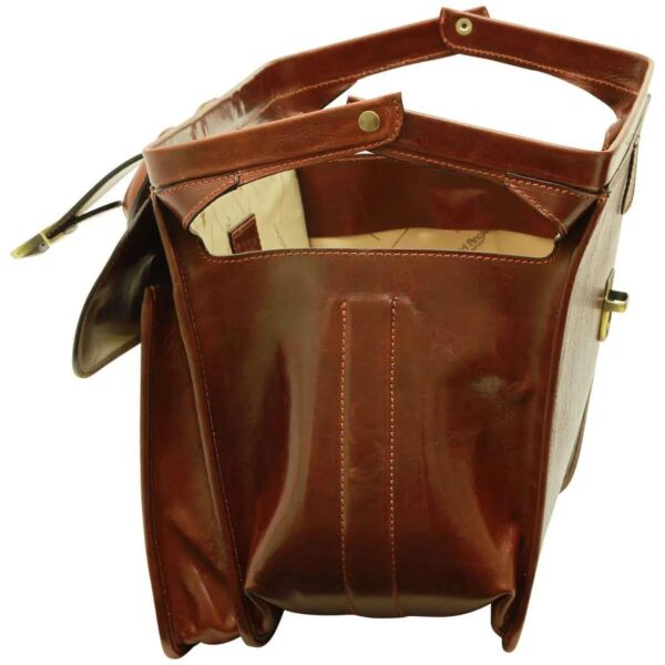 Side view of an open brown leather Gladstone bag, showing the fully extended metal hinged frame, side reinforcement stitching, and a glimpse of the patterned interior lining, isolated on a white background.