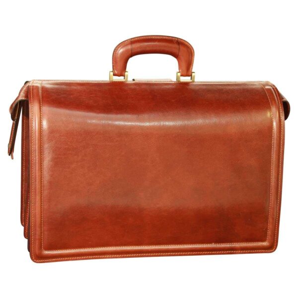 A rear view of a cognac-colored leather doctor-style briefcase, featuring a sturdy top handle with gold-tone metal hardware and a clean, polished finish.