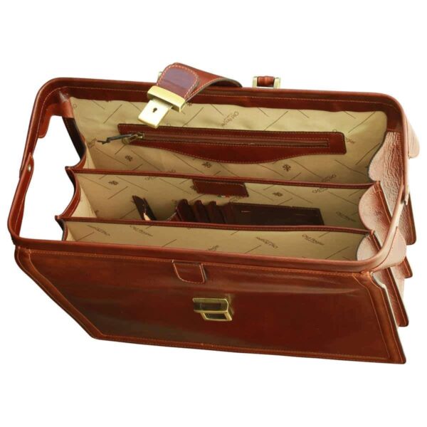 An interior view of an open, cognac-colored leather doctor-style briefcase, revealing a beige patterned lining, multiple compartments, an internal zippered pocket, and dedicated slots for cards or pens.