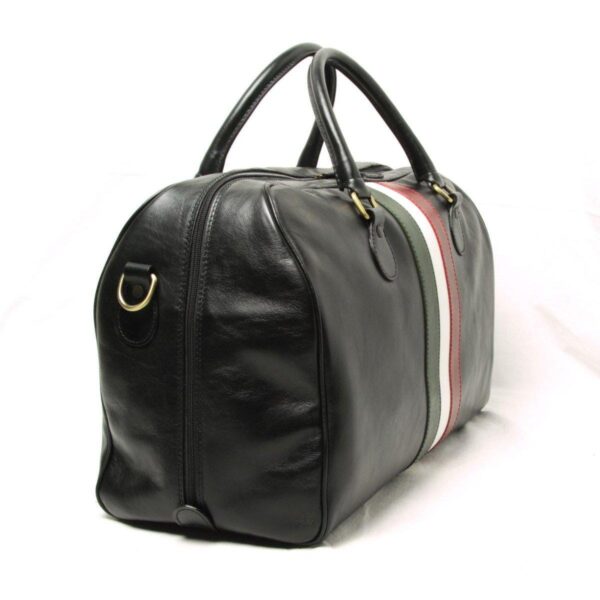 A side-angled view of the black leather duffel bag, showing the brass D-ring for the shoulder strap attachment and the side profile of the bag, with the green, white, and red stripes wrapping across the center.