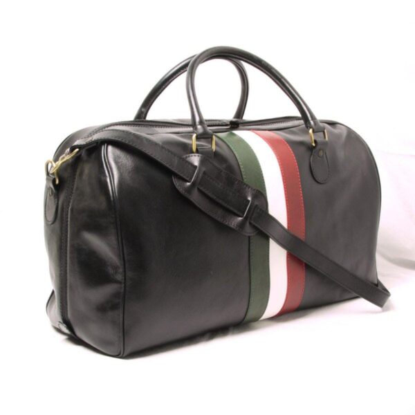 A studio shot of a black leather duffel bag with a detachable shoulder strap, featuring a prominent vertical tri-color stripe in green, white, and red on the side.