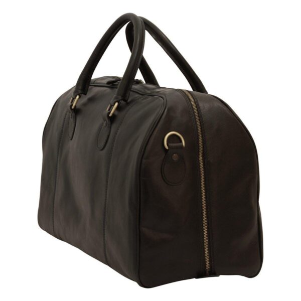 A side-angle view of a black leather duffel bag, highlighting a vertical side zipper, brass-tone hardware, and rounded leather carry handles.